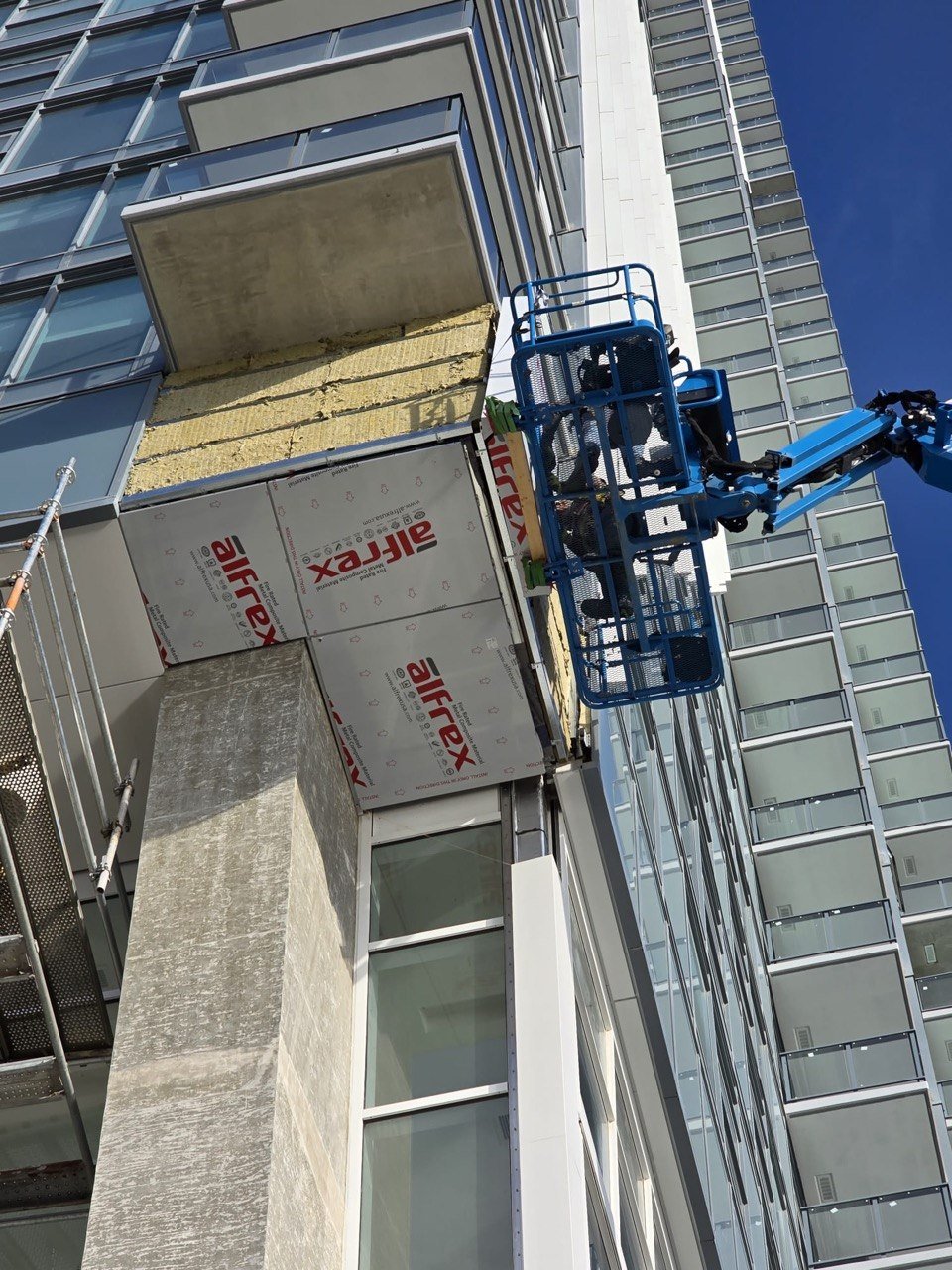 Pier West Alfrex panel installation at height from boom lift